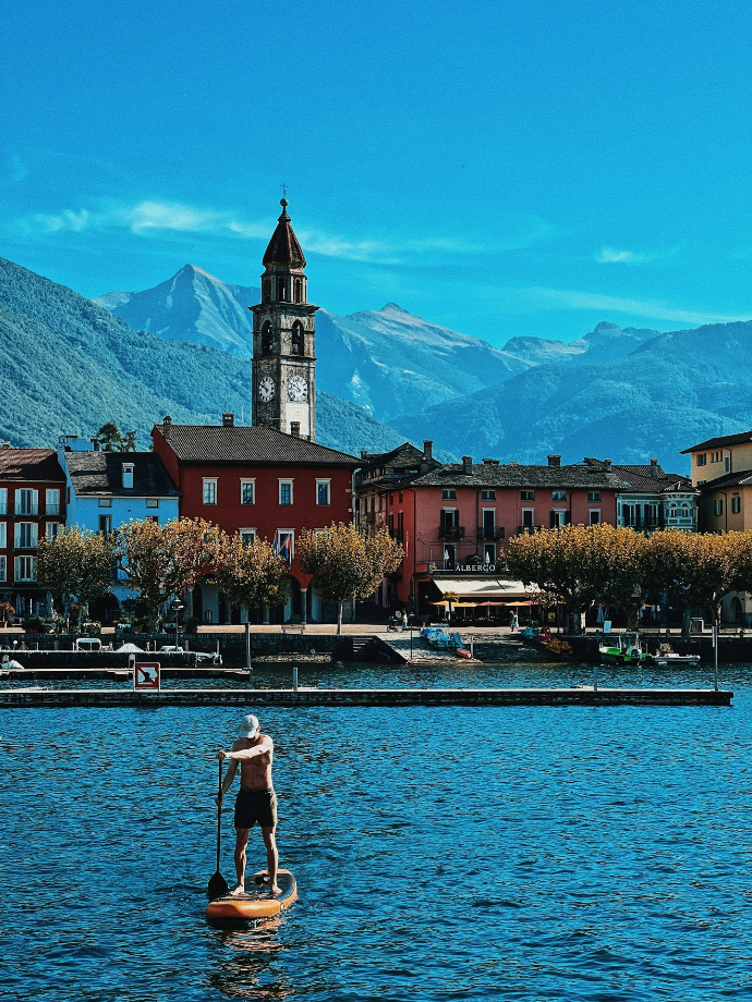 a man riding a paddle board on top of a lake